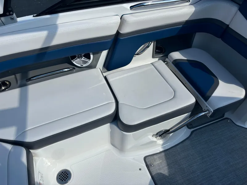 Slide: The Image of 2016 Chaparral Vortex 203 VRX boat interior seating with blue and white upholstery. - 2