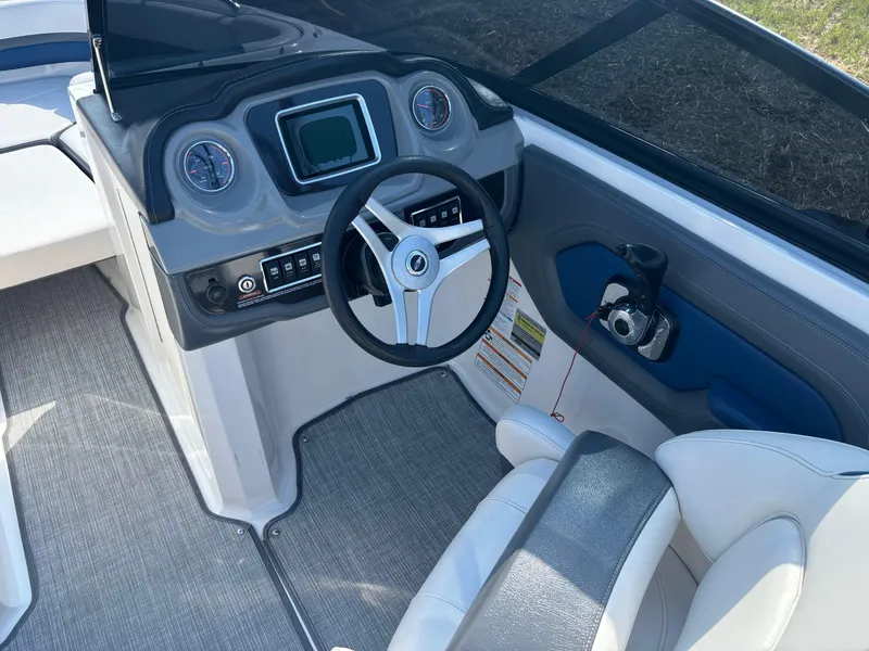 Slide: The Image of 2016 Chaparral Vortex 203 VRX boat cockpit with steering wheel and dashboard controls. - 3
