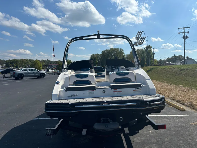 Slide: The Image of 2016 Chaparral Vortex 203 VRX boat, rear view, parked outdoors under a blue sky. - 7