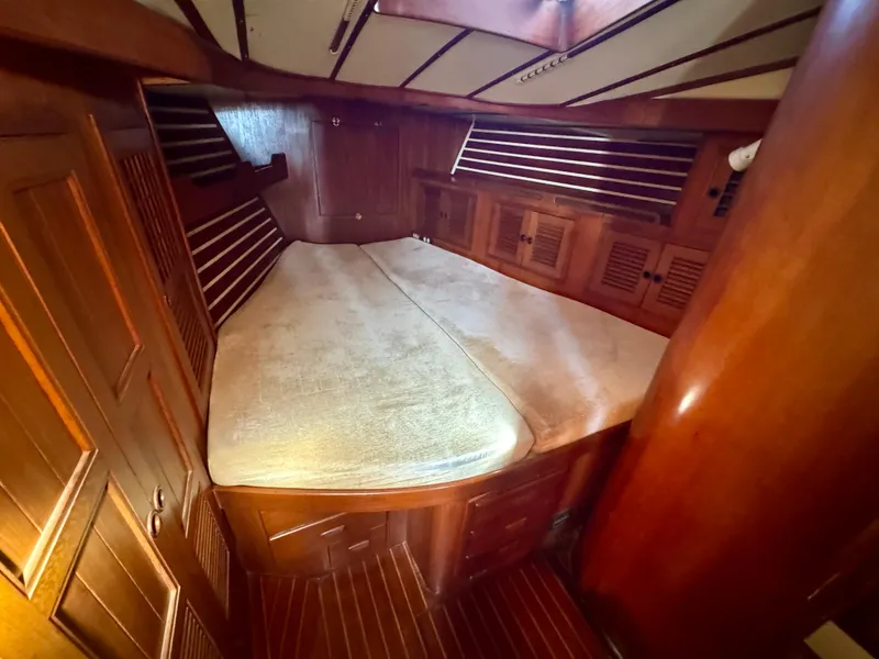 Slide: The Image of Cozy cabin interior of 1983 Tayana 52 Aft Cockpit sailboat with wooden finishes. - 12