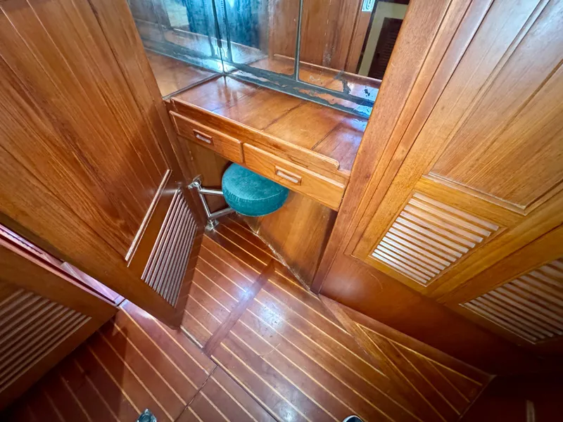Slide: The Image of Wooden interior of 1983 Tayana 52 Aft Cockpit yacht with vanity and stool. - 18