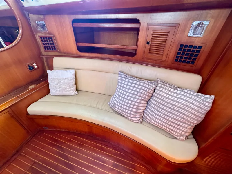 Slide: The Image of Cozy seating area in 1983 Tayana 52 Aft Cockpit yacht with striped cushions. - 19