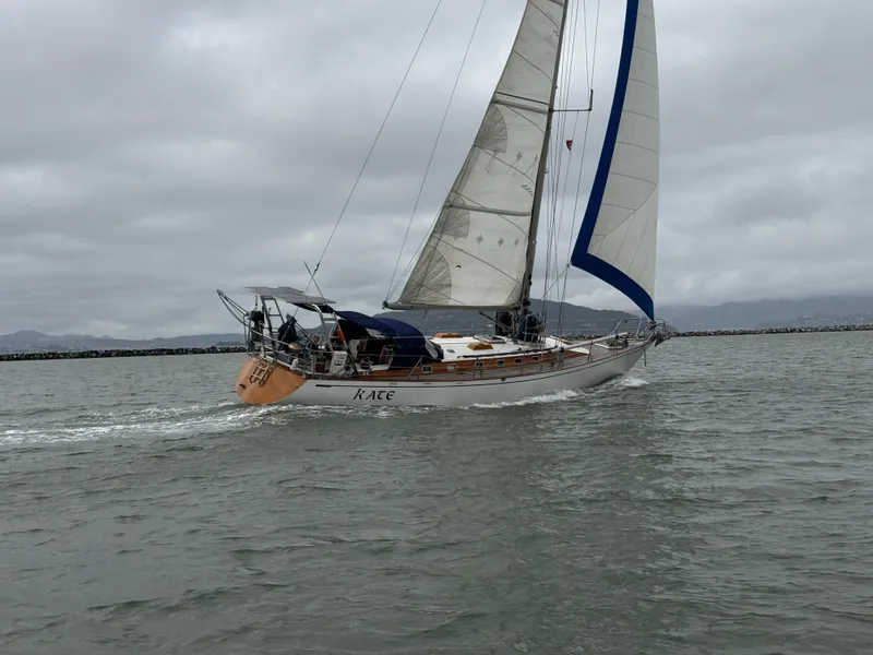 Slide: The Image of 1983 Tayana 52 Aft Cockpit sailboat navigating on a cloudy day. - 3