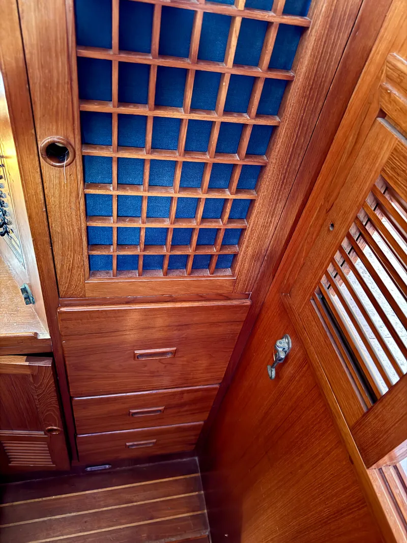 Slide: The Image of Wooden interior of 1983 Tayana 52 Aft Cockpit sailboat with lattice cabinet and drawers. - 33
