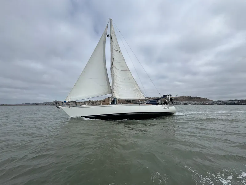 Slide: The Image of 1983 Tayana 52 Aft Cockpit sailboat cruising on a cloudy day. - 4