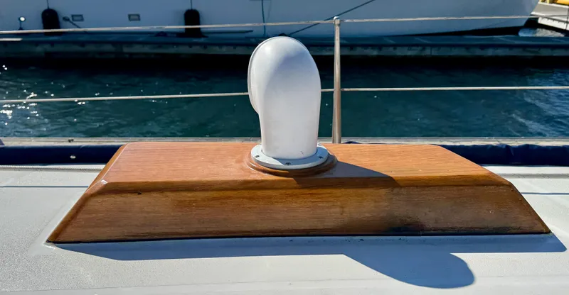 Slide: The Image of Wooden deck vent on 1983 Tayana 52 Aft Cockpit yacht, docked by the water. - 45