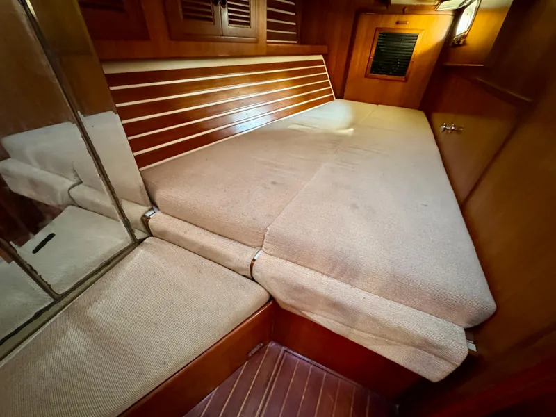 Slide: The Image of Cozy cabin interior of 1983 Tayana 52 Aft Cockpit yacht with cushioned seating. - 9