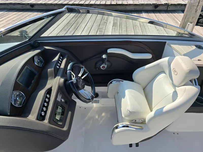 Slide: The Image of 2015 Cobalt R7 boat interior with steering wheel and white captain's chair. - 11