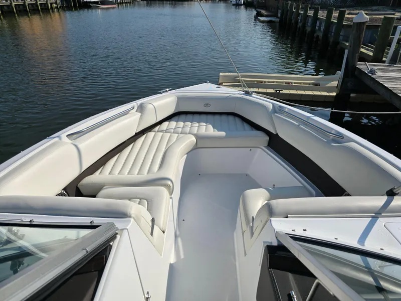 Slide: The Image of 2015 Cobalt R7 boat with white seating, docked by the water. - 13