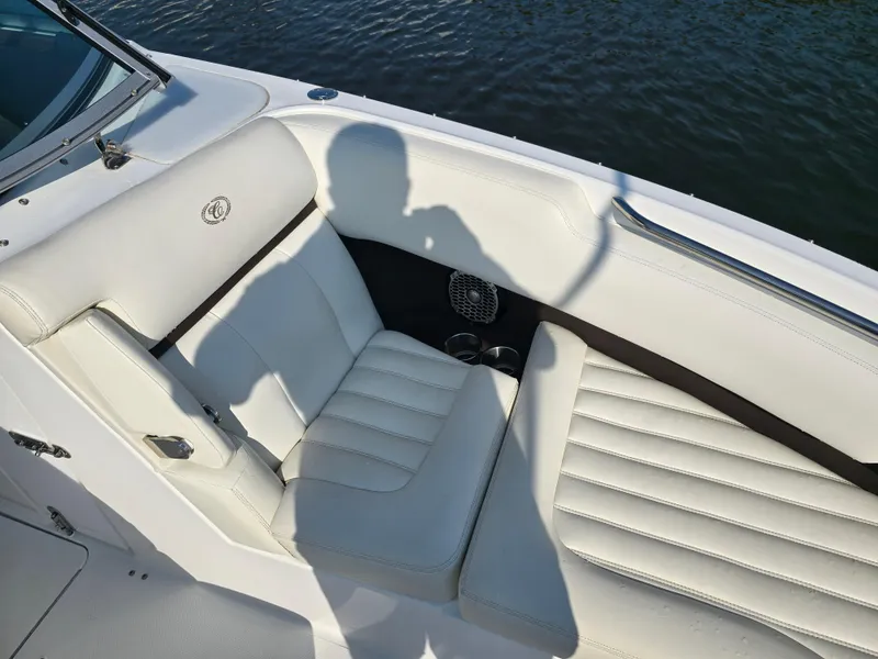 Slide: The Image of 2015 Cobalt R7 boat with white leather seating by the water. - 14