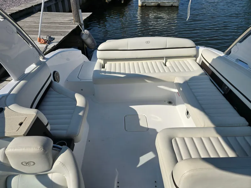 Slide: The Image of 2015 Cobalt R7 boat interior with white leather seating near dock. - 3