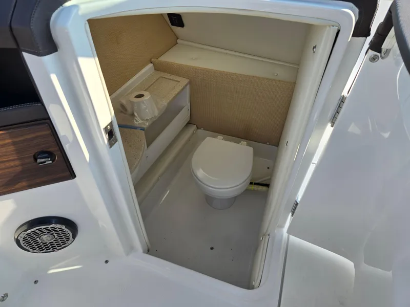 Slide: The Image of 2015 Cobalt R7 boat interior bathroom with toilet and storage shelf. - 6