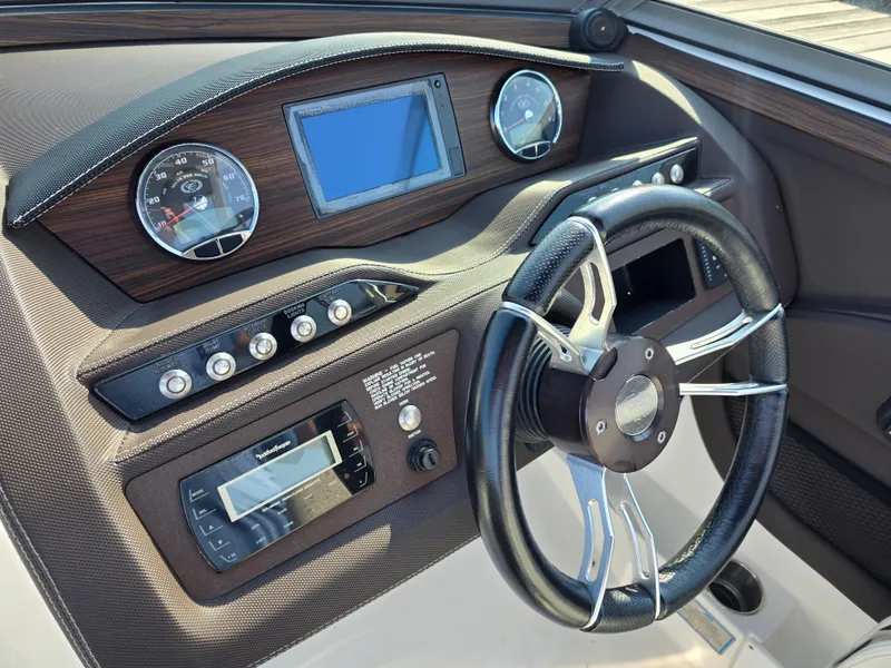 Slide: The Image of 2015 Cobalt R7 boat dashboard with steering wheel and gauges. - 7
