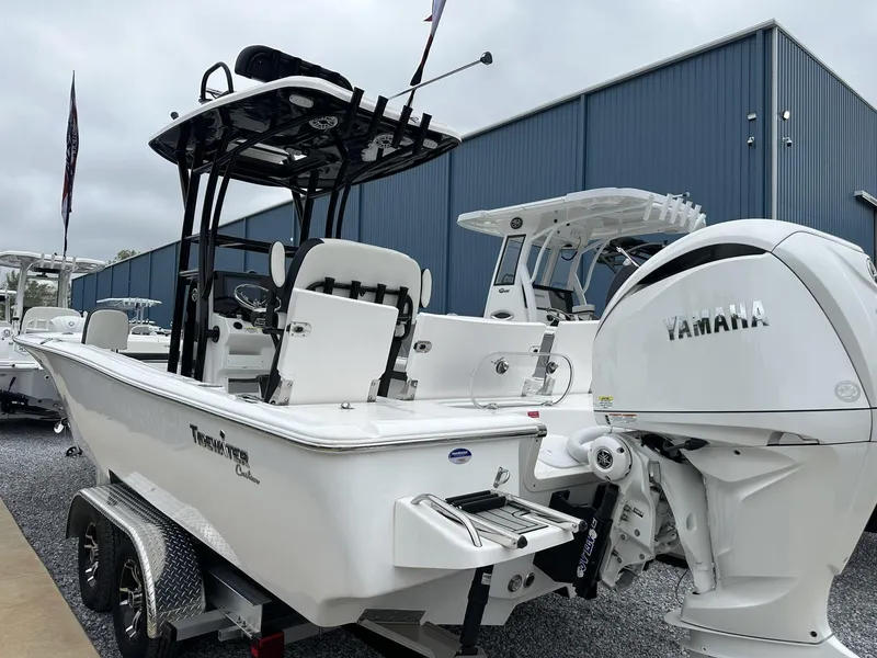 Slide: The Image of 2025 Tidewater 2500 Carolina Bay boat with Yamaha engine, displayed outdoors. - 15