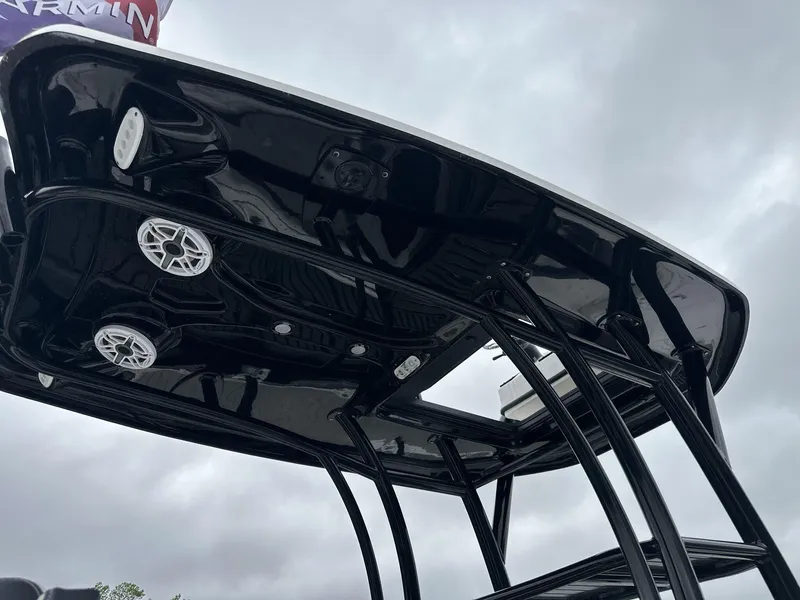 Slide: The Image of Tidewater 2500 Carolina Bay boat's second station with speakers, 2025 model, under cloudy sky. - 19