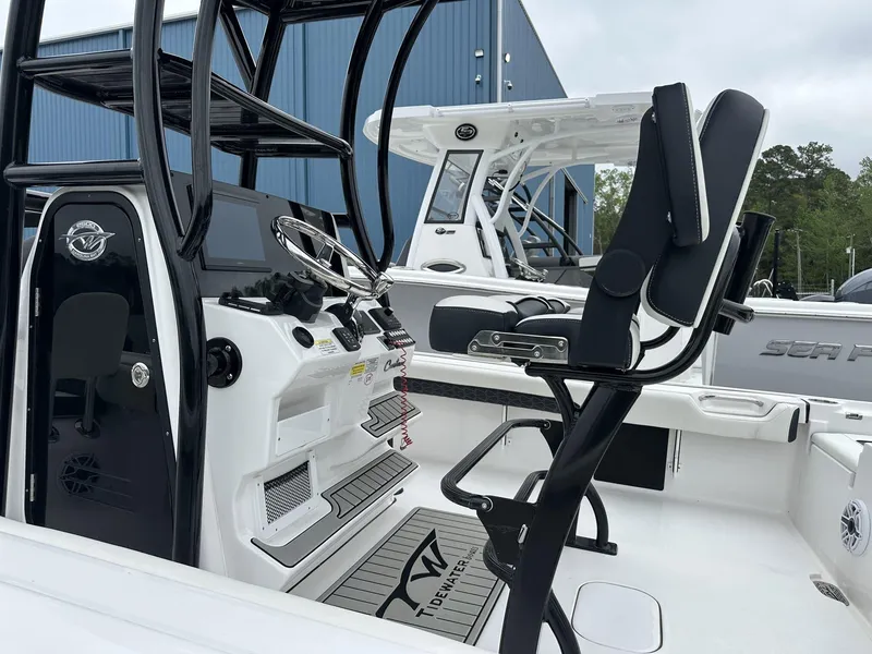 Slide: The Image of 2025 Tidewater 2500 Carolina Bay boat interior with second station, featuring modern controls and seating. - 9