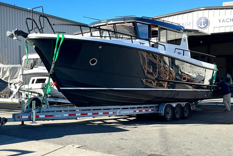 Slide: The Image of 2024 Sargo 36 Explorer boat on trailer outside yacht storage facility. - 13