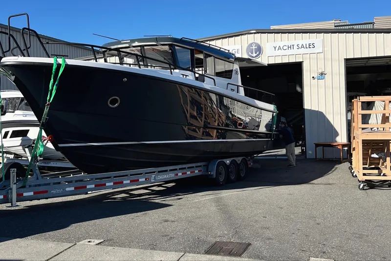 Slide: The Image of 2024 Sargo 36 Explorer yacht on trailer outside yacht sales building. - 15