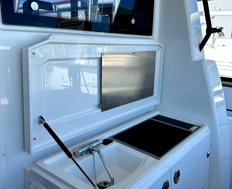 Slide: The Image of 2024 Sargo 36 Explorer boat kitchen area with sink and stove. - 19