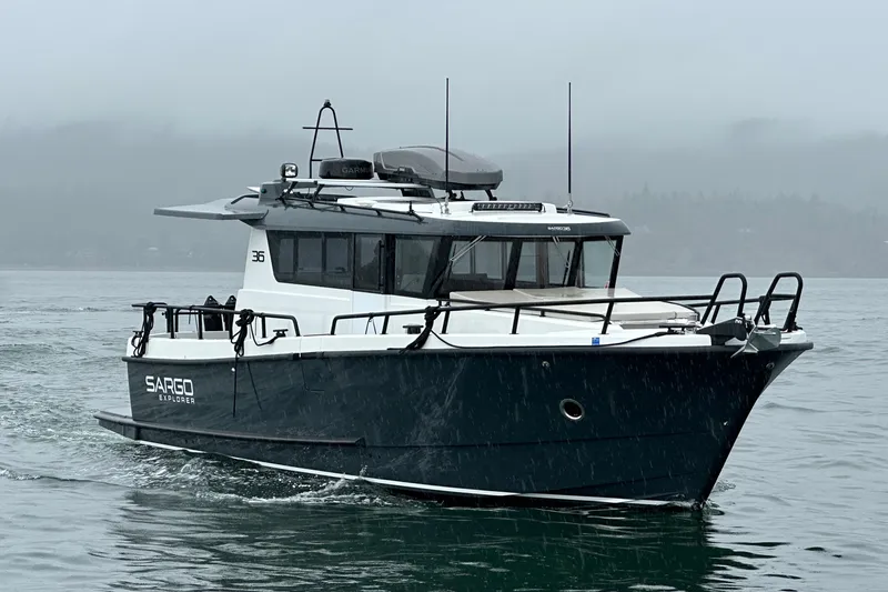Slide: The Image of 2024 Sargo 36 Explorer boat cruising on a misty waterway. - 2