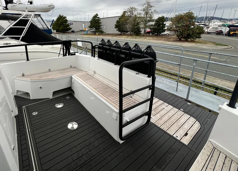 Slide: The Image of 2024 Sargo 36 Explorer boat deck with seating and railing, docked at marina. - 23