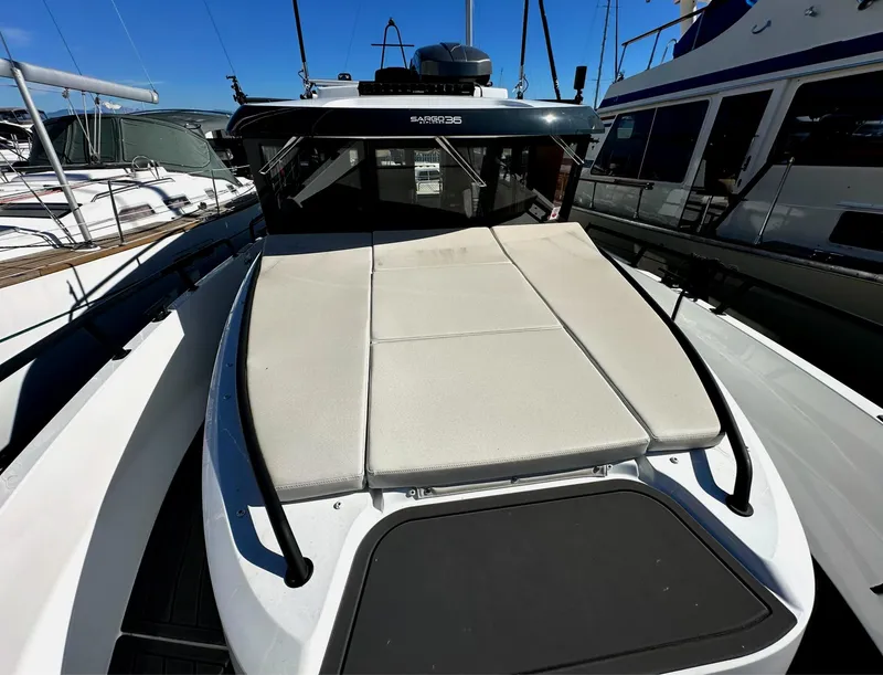 Slide: The Image of 2024 Sargo 36 Explorer boat with sunbathing deck, docked at marina. - 25