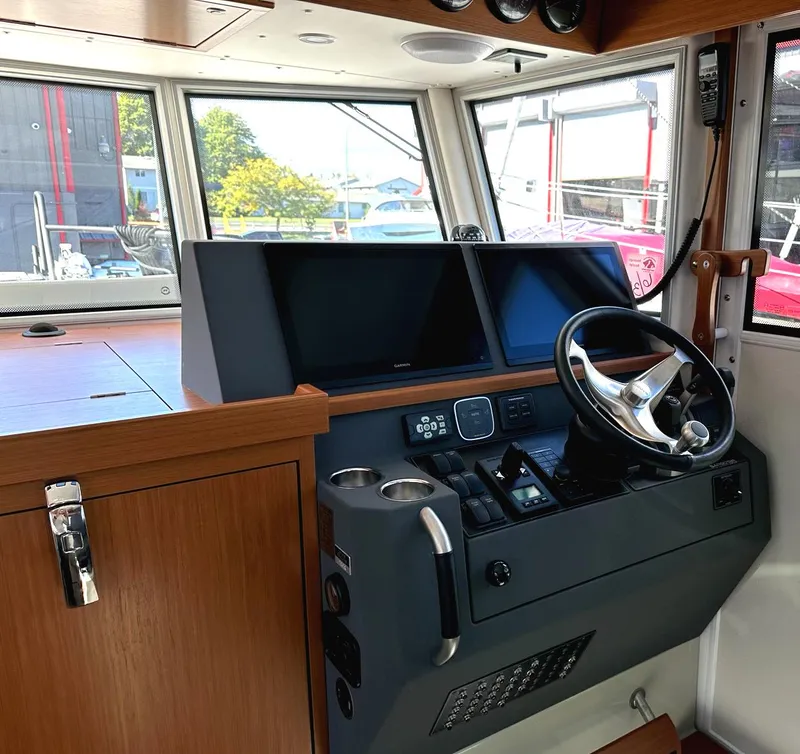 Slide: The Image of 2024 Sargo 36 Explorer helm with modern navigation screens and steering wheel. - 37