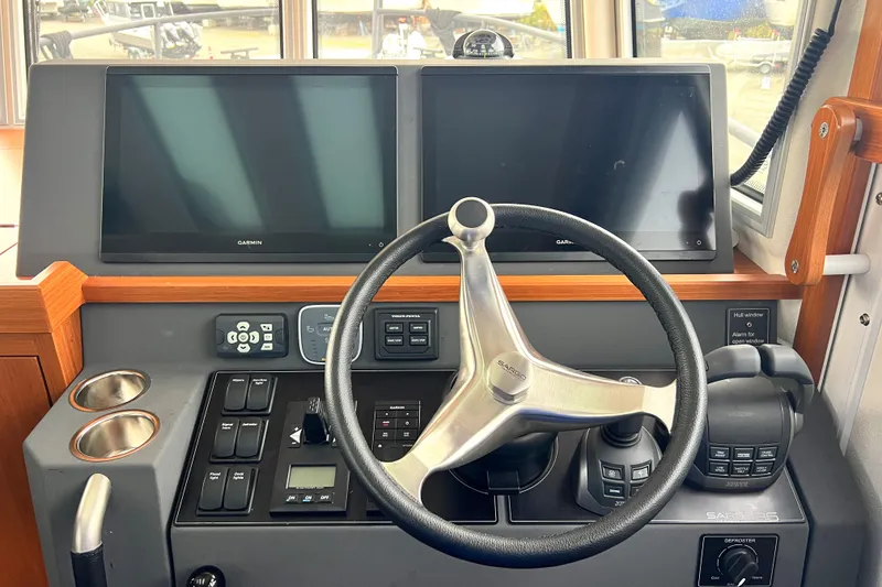 Slide: The Image of 2024 Sargo 36 Explorer helm with dual screens and modern controls. - 38