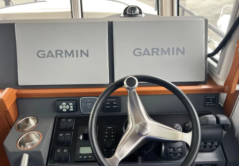 Slide: The Image of 2024 Sargo 36 Explorer helm with Garmin navigation displays and steering wheel. - 39