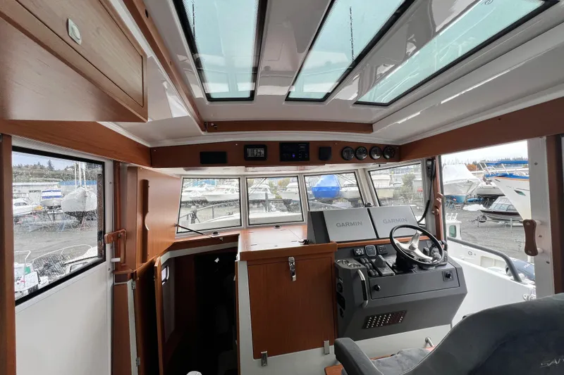 Slide: The Image of Interior of 2024 Sargo 36 Explorer boat with modern helm and panoramic windows. - 55