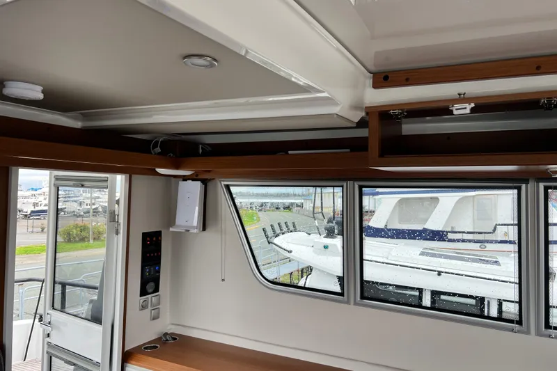 Slide: The Image of Interior view of 2024 Sargo 36 Explorer boat with large windows and wooden accents. - 56