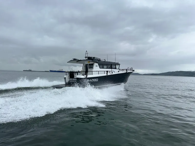 Slide: The Image of 2024 Sargo 36 Explorer cruising on open water under cloudy skies. - 6