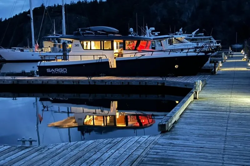 Slide: The Image of 2024 Sargo 36 Explorer docked at night, reflecting on calm water. - 9