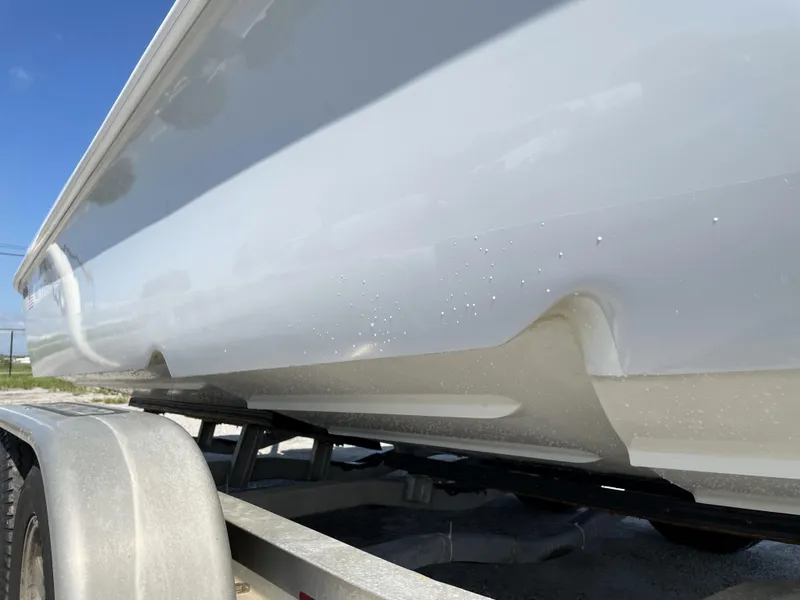 Slide: The Image of 2015 Contender 25 Bay boat on trailer, side view. - 10