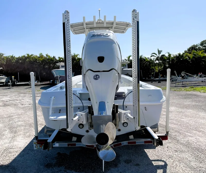 Slide: The Image of 2015 Contender 25 Bay boat on trailer, rear view, sunny day. - 12