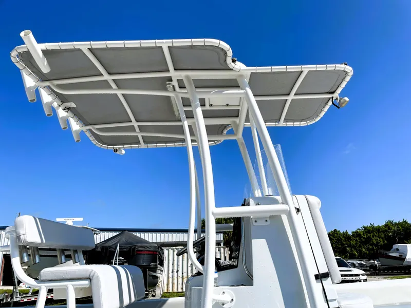 Slide: The Image of 2015 Contender 25 Bay boat with T-top under clear blue sky. - 22