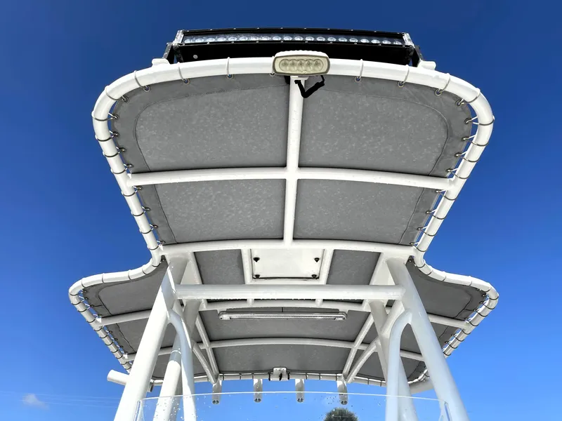 Slide: The Image of Contender 25 Bay 2015 boat T-top against clear blue sky. - 23