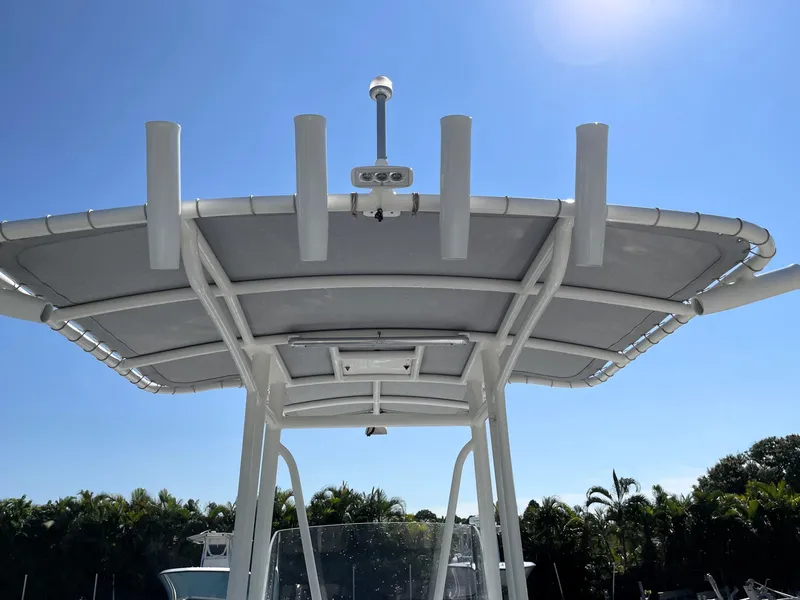 Slide: The Image of 2015 Contender 25 Bay boat T-top under clear blue sky. - 24