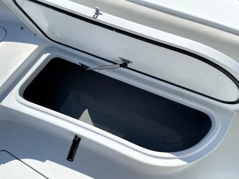 Slide: The Image of Open storage compartment on 2015 Contender 25 Bay boat. - 36