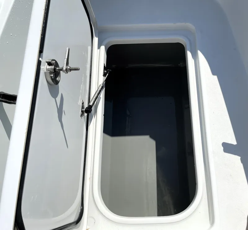 Slide: The Image of Open storage compartment on 2015 Contender 25 Bay boat. - 37