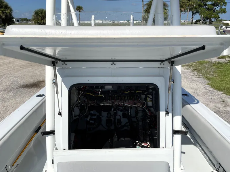 Slide: The Image of 2015 Contender 25 Bay boat console with open hatch, revealing internal wiring and components. - 39