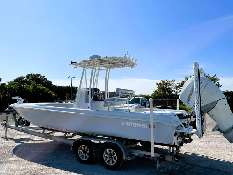 Slide: The Image of 2015 Contender 25 Bay boat on trailer under clear blue sky. - 4
