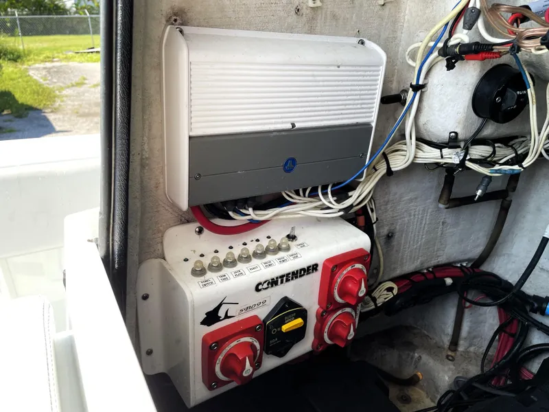 Slide: The Image of Electrical panel of a 2015 Contender 25 Bay boat with wiring and switches. - 42