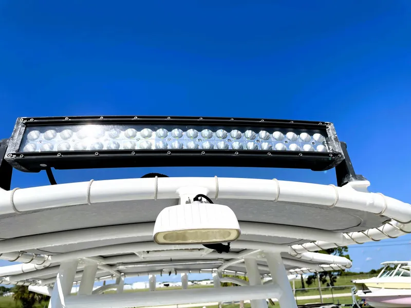 Slide: The Image of 2015 Contender 25 Bay boat with LED light bar against clear blue sky. - 46