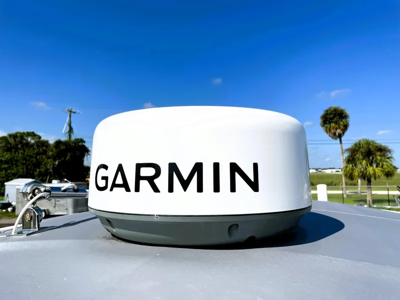 Slide: The Image of Garmin radar on 2015 Contender 25 Bay boat under clear blue sky. - 47
