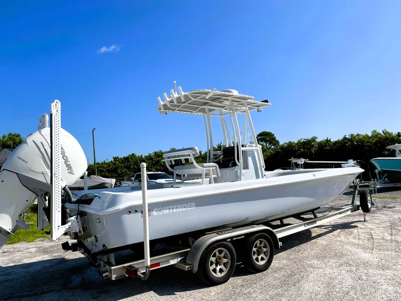 Slide: The Image of 2015 Contender 25 Bay boat on trailer under clear blue sky. - 5