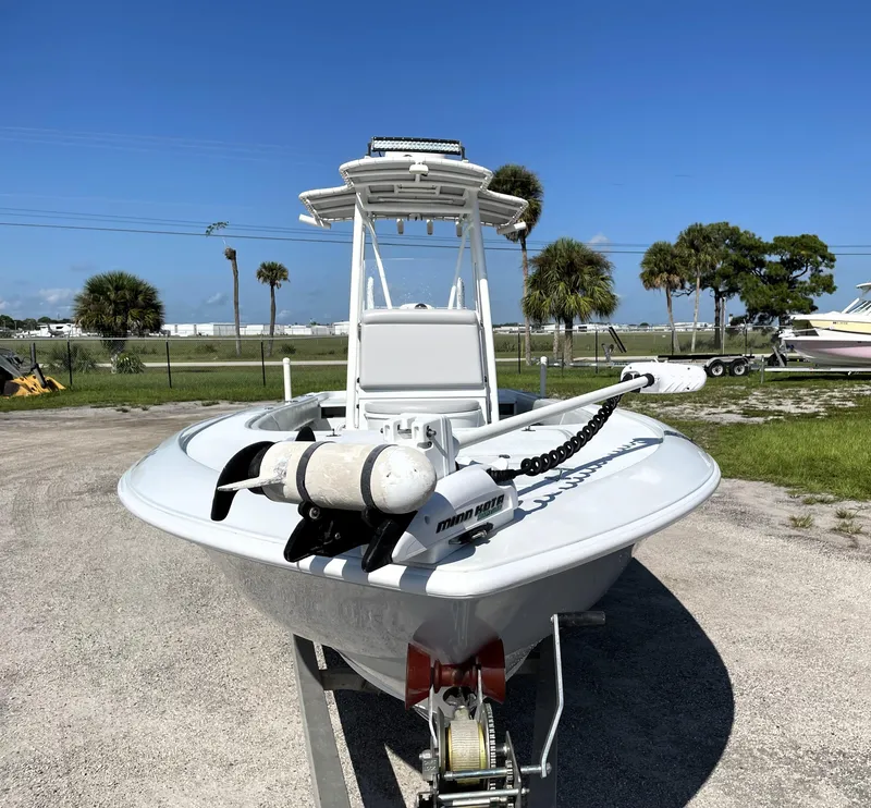 Slide: The Image of 2015 Contender 25 Bay boat on trailer, parked outdoors under clear blue sky. - 6