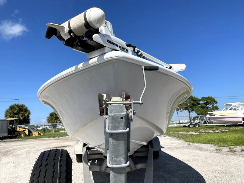Slide: The Image of 2015 Contender 25 Bay boat on trailer under clear blue sky. - 7