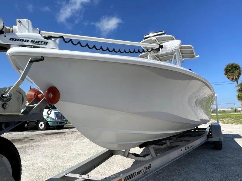 Slide: The Image of 2015 Contender 25 Bay boat on trailer under clear blue sky. - 9