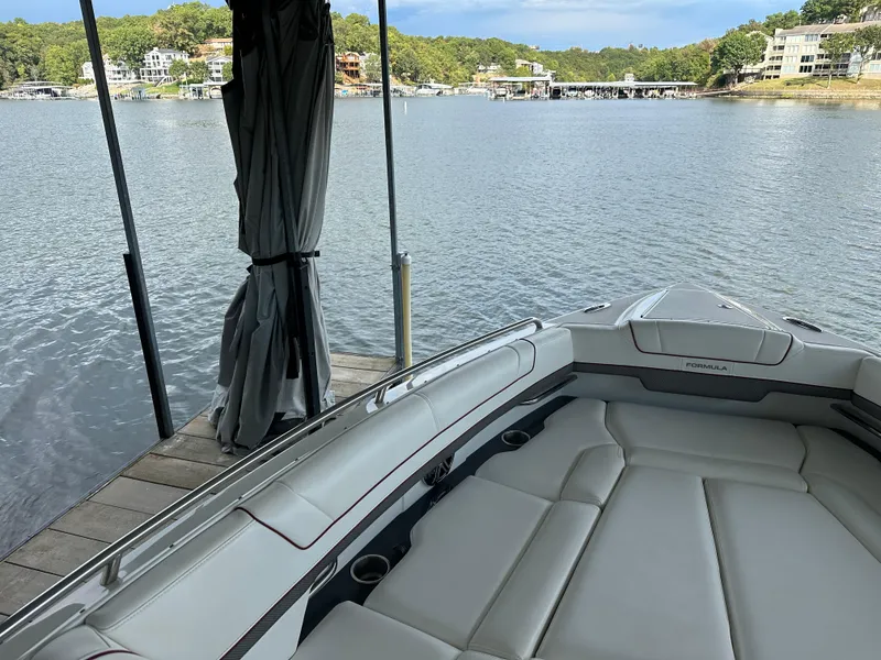 Slide: The Image of 2016 Formula 330 Crossover Bowrider docked by a scenic lake. - 13